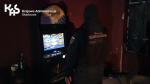 Sylwetka funkcjonariusza stojącego przed automatem do gier
