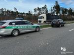 radiowóz Służby Celno-Skarbowej i uszkodzony w wypadku samochód na autostradzie